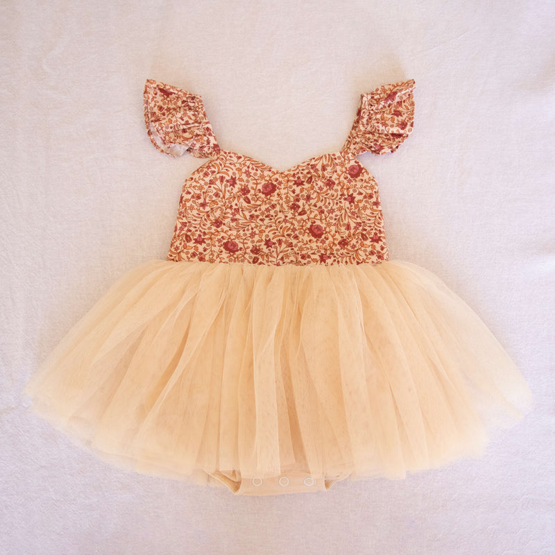 Everly floral and tulle romper studio image showing the beautiful neutral and red floral, and cream tulle skirt.