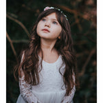 Girl wears our Briar flower girl dress, showing close details of the lace bodice.