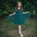 Gabrielle green flower girl dress is styled for Christmas and worn by a young girl.