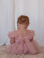 Gabrielle dusty pink flower girl romper shown from the back, showing the tulle tie bow.