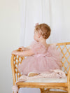 Back of our Gabrielle tulle baby flower girl dress in dusty pink, showing tulle bow at the back of the dress.