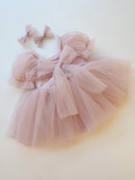 Gabrielle tulle puff sleeve flower girl baby romper in dusty pink. Showing the back with tulle bow.