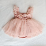 Gigi tulle baby special occasion outfit in peach blush shown from the back. With a tulle skirt and flutter sleeves, as well as a feature tulle bow at the back.