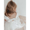 Gigi ivory flower girl dress shown from behind, showing the tulle bow at the back of the dress.