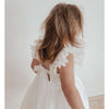 Gigi ivory flower girl dress shown from behind, showing the tulle flutter sleeves and tulle bow at the back.