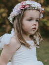 Luna girls flower crown in ivory, pink and lilac tones is worn by a young girl. She also wears our Harper white flower girl dress in tea length.