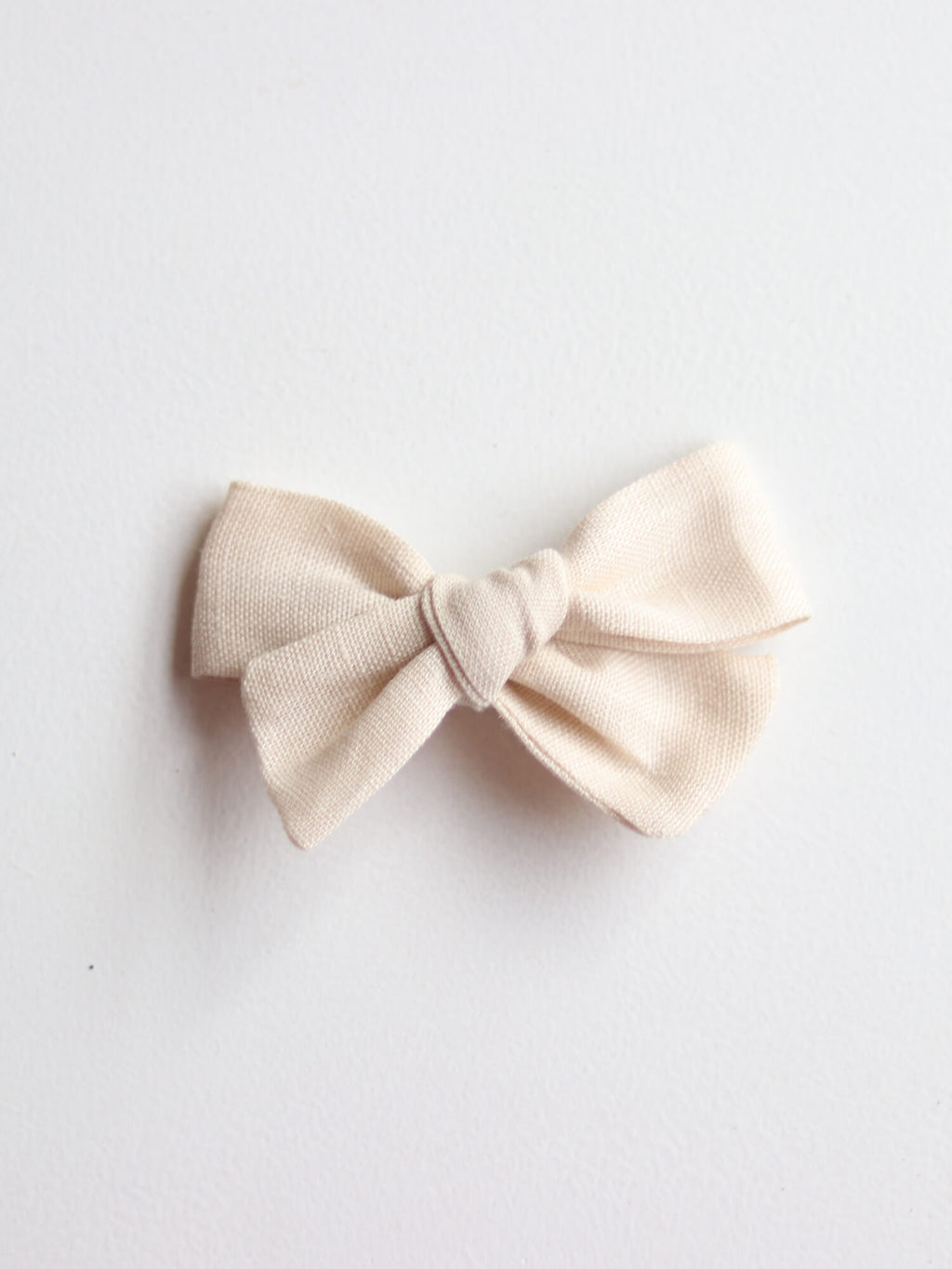 Cream linen bow hair clip for flower girls.