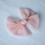 Medium tulle bow clip in peachy blush.
