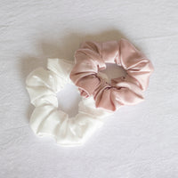 Girls and women's mulberry silk scrunchies in ivory and blush.