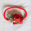 Chloe Christmas floral headband in red. Studio photo shows the flower crowns beautiful festive details on a red soft elastic headband.