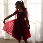 Rosie dress in wine is worn by a young girl. A perfect girls Christmas outfit or wine flower girl dress.