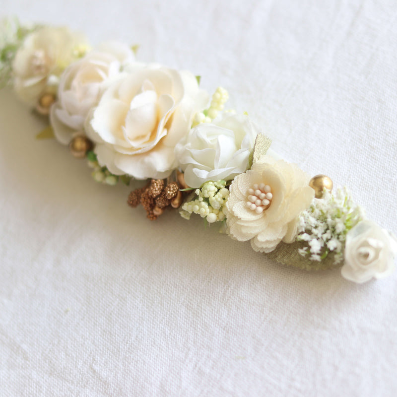 Baby girl ivory floral headband shown close up, showing ivory florals with gold accents and sage greenery.