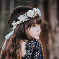 Sage ivory flower crown worn by a young flower girl.