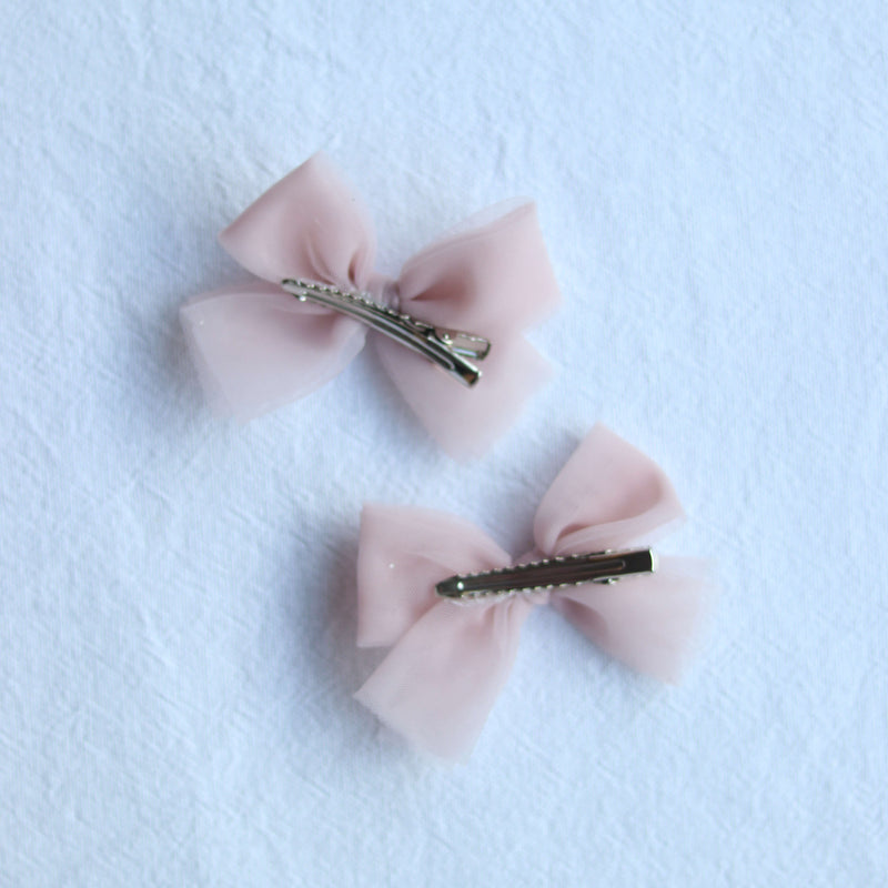 The back of our small pigtail bows in dusty pink.
