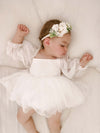 Long tulle sleeve baby flower girl dress is worn by a toddler, along with an ivory baby floral headband.