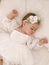 Tulle sleeve baby flower girl romper dress is worn by a toddler, along with a floral headband.